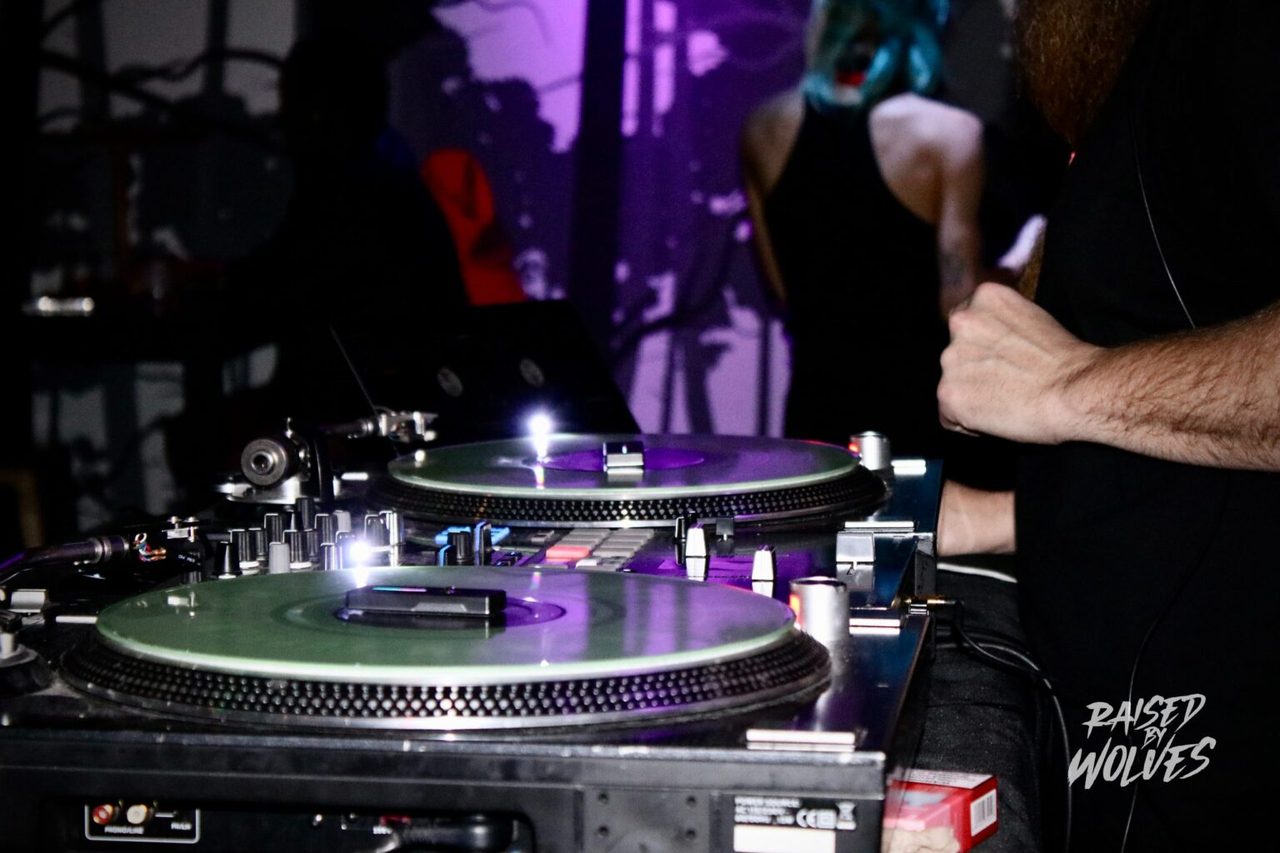 DJ turntables under the purple forest glow at Raised By Wolves Las Vegas